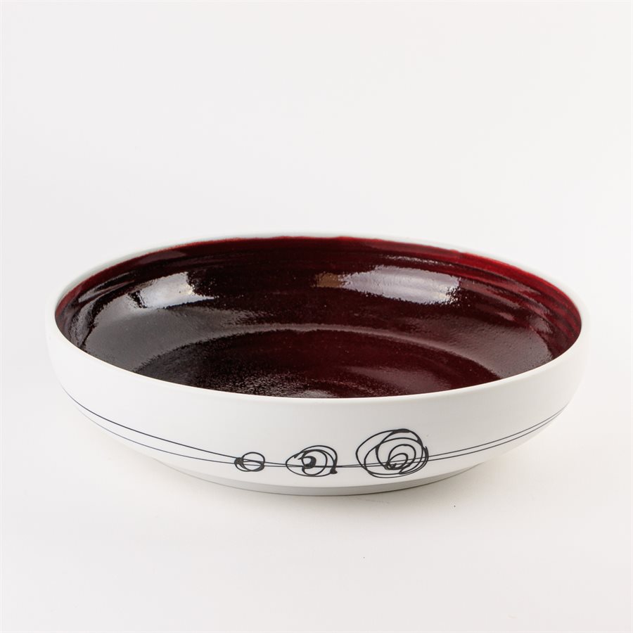 Large porcelain serving bowl with red interior