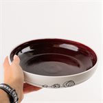 Large porcelain serving bowl with red interior