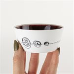 Small flared ceramic bowl with red interior