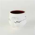 Miniature porcelain cup with red interior