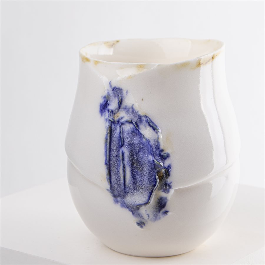 Petit verrre en porcelaine, contour oxydé et ornement bleu Petit verrre en porcelaine, contour oxydé et ornement bleu