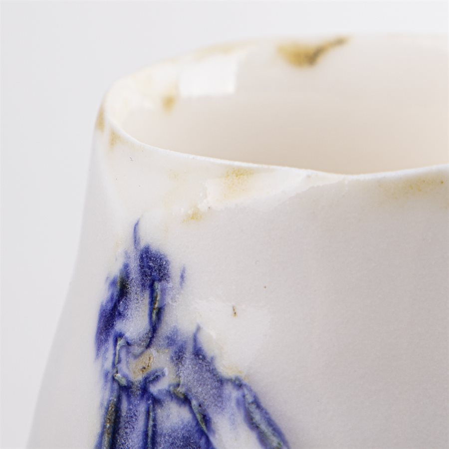 Petit verrre en porcelaine, contour oxydé et ornement bleu Petit verrre en porcelaine, contour oxydé et ornement bleu