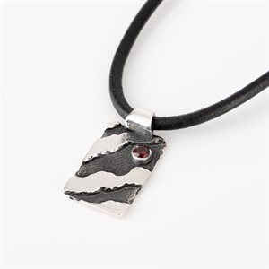 Silver pendant with garnet stone on leather cord